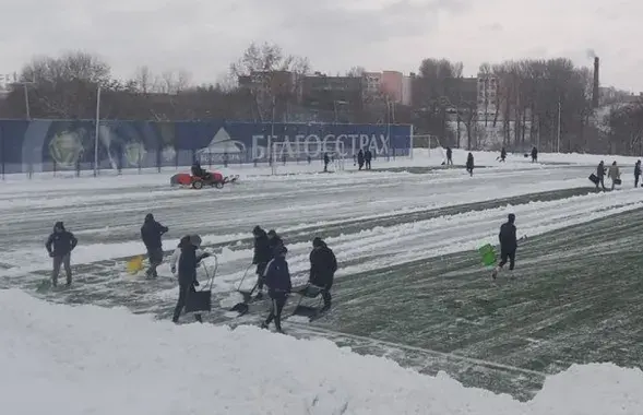 Футбалісты прыбіраюць снег на стадыёне ў Мінску / t.me/footballby
